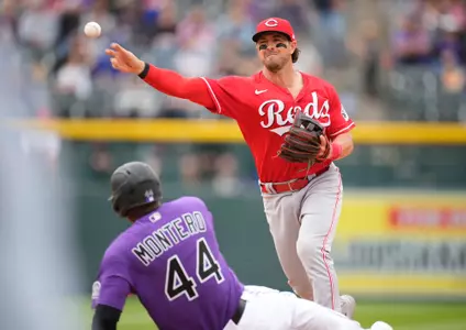 Cincinnati Reds shortstop Kyle Farmer, right, throws over Colorado Rockies' Elehuris Montero (44) after forcing Montero out at second base on the front end of a double play hit into by Jose Iglesias to end the seventh inning of a baseball game Sunday, May 1, 2022, in Denver. (AP Photo/David Zalubowski)
