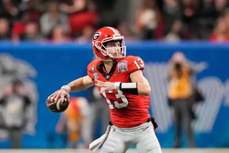 Dec 31, 2022; Atlanta, Georgia, USA; Georgia Bulldogs quarterback Stetson Bennett (13) passes the ball against the Ohio State Buckeyes during the first quarter of the 2022 Peach Bowl at Mercedes-Benz Stadium. Mandatory Credit: Dale Zanine-USA TODAY Sports