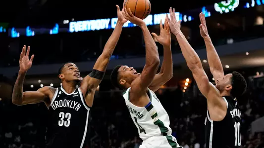 Brooklyn Nets' Nic Claxton (33) blocks a shot attempt by Milwaukee Bucks' Giannis Antetokounmpo (34) during the second half of an NBA preseason basketball game Wednesday, Oct. 12, 2022, in Milwaukee. (AP Photo/Aaron Gash)