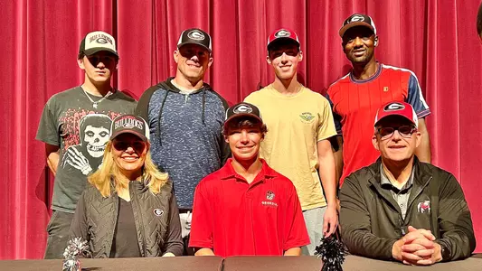 Aidan Atwood with his family after signing his NLI.