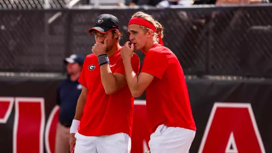Teodor Giusca and Philip Henning talk strategy in doubles against Vanderbilt on March 11, 2023.