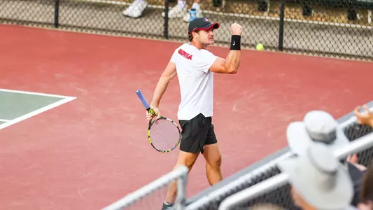 Trent Bryde celebrating after earning a point in Georgia's match against No. 5 Kentucky on March 31, 2023.