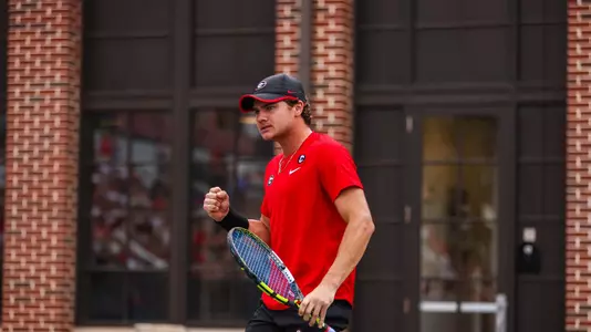 Trent Bryde pumps his fist after winning a point during the team's match against Kentucky on March 31, 2023, where the Bulldogs beat the No. 4 Wildcats by a 4-3 result.