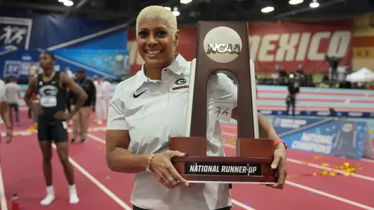Mar 11, 2023; Albuquerque, New Mexico, USA; Georgia Bulldogs coach Caryl Smith Gilbert poses with the men's national runner-up team trophy the NCAA Indoor Championships at Albuquerque Convention Center. Mandatory Credit: Kirby Lee-USA TODAY Sports