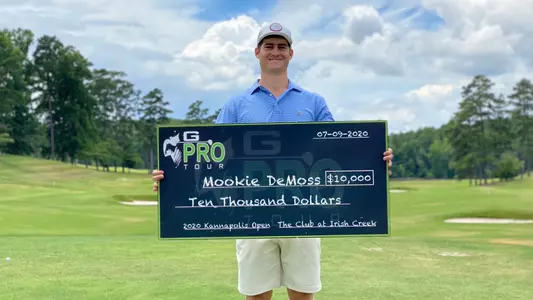 Assistant Golf Coach Mookie DeMoss posing after winning the 2020 Kannapolis Open.