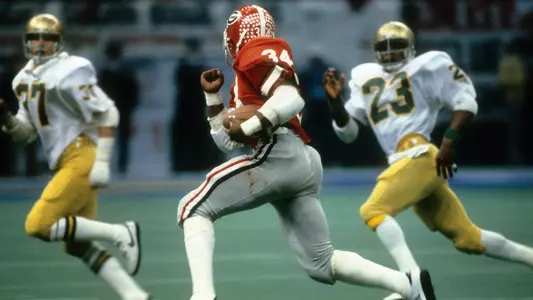 LOUISIANA, NO - JANUARY 1: Running back Herschel Walker #34 of the University of Georgia Bull Dogs carries the ball against the Notre Dame Fighting Irish during the Sugar Bowl game January 1, 1981 at the Louisiana Superbowl in New Orleans, Louisiana. The Bull Dogs won the game 17-10. Walker played at the University of Georgia from 1980-1983, and won the Heisman Trophy in 1982. (Photo by Focus on Sport/Getty Images)