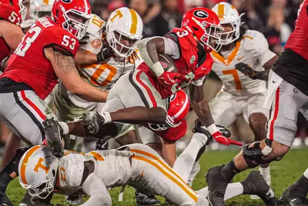 Nov. 16 2024; Athens, Georgia, USA; Georgia Bulldogs running back Nate Frazier (3) is tackled by Tennessee Volunteers defensive lineman James Pearce Jr. (27) during the first half at Sanford Stadium. Mandatory Credit: Dale Zanine-Imagn Images