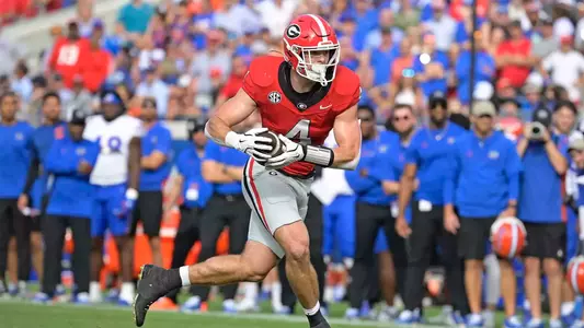 Nov 2, 2024; Jacksonville, Florida, USA; Georgia Bulldogs tight end Oscar Delp (4) advances the ball against the Florida Gators during the first half at EverBank Stadium. Mandatory Credit: Melina Myers-Imagn Images