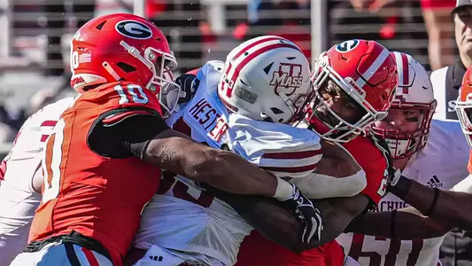 Nov 23, 2024; Athens, Georgia, USA; Georgia Bulldogs linebacker Damon Wilson II (10) and linebacker Smael Mondon Jr. (2) combine to tackle Massachusetts Minutemen running back CJ Hester (33) during the first quarter at Sanford Stadium. Mandatory Credit: Dale Zanine-Imagn Images