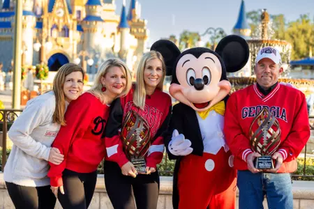 Megan Twist’s sisters Katy Williams, Jane Hixson and Carolyn Hostetler receive the 2024 Disney Spirit Award on her behalf along with Richard Bremer at Walt Disney World Resort in Florida on Dec. 2, 2024. Bremer and Twist were selected for the award after Twist’s donated lungs saved Bremer’s life and inspired him to switch his football allegiance from the Florida Gators to Twist’s favorite team, the Bulldogs. Bremer has also become a passionate advocate for organ donation. The Disney Spirit Award is presented annually to the most inspiring figures in college football. (Olga Thompson, photographer)