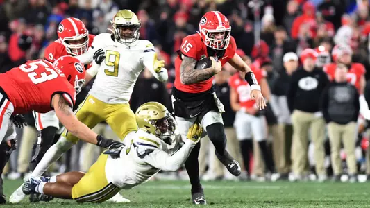 Carson Beck #15 of the Georgia Bulldogs runs with the ball