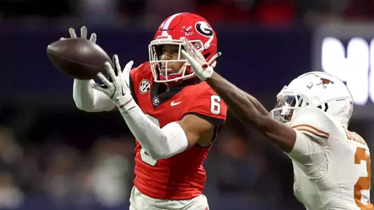Dec 7, 2024; Atlanta, GA, USA; Georgia Bulldogs wide receiver Dominic Lovett (6) makes a catch against Texas Longhorns defensive back Derek Williams Jr. (2) during the second half in the 2024 SEC Championship game at Mercedes-Benz Stadium. Mandatory Credit: Brett Davis-Imagn Images