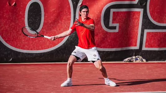 Parker Jacques returning a shot during doubles action of the team's match against The Citadel on 03/24/24.