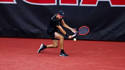 Thomas Paulsell returning a shot at the Lindsey Hopkins Indoor Tennis Facility in the team's match against LSU on March 22, 2024.