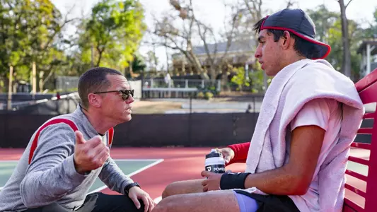 Assistant Coach Bryce Warren and Cyrus Mahjoob talk during a changeover at the team's match against Georgia Tech.