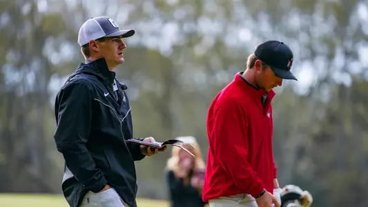 Buck Brumlow and assistant coach Mookie DeMoss prior to a tee shot during the first round of the Linger Longer Invitational.