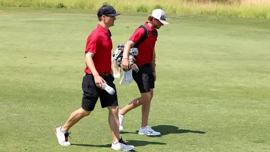 Graduate Connor Creasy and assistant coach Mookie DeMoss discussing the hole while at the SEC Championships.
