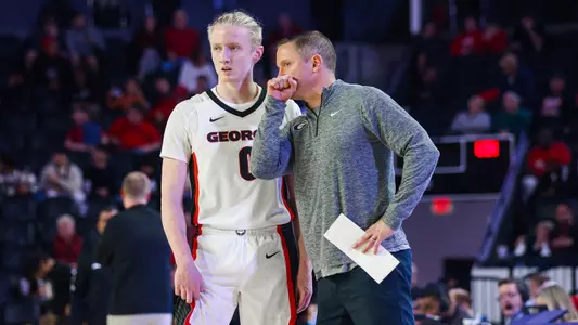 Mike White talks to Blue Cain during the Winthrop game of the 2023-24 season (photo by Cassie Baker).
