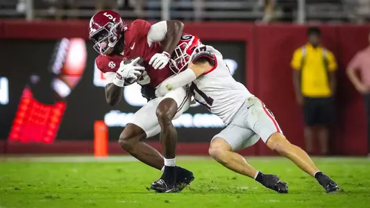 Sep 28, 2024; Tuscaloosa, Alabama, USA; Georgia Bulldogs defensive back Dan Jackson (17) brings down Alabama Crimson Tide wide receiver Germie Bernard (5) during the first quarter at Bryant-Denny Stadium. Mandatory Credit: Will McLelland-Imagn Images