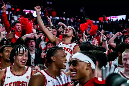 Georgia's men's basketball team celebrates with the student section after beating No. 17 Oklahoma