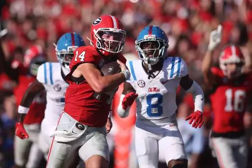 Athens, Georgia, USA; Georgia Bulldogs quarterback Gunner Stockton (14) runs for a touchdown against Mississippi Rebels cornerback Antonio Kite (8) during the second quarter at Sanford Stadium. Mandatory Credit: Brett Davis-Imagn Images