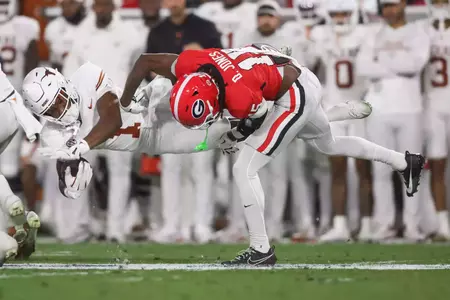 Nov 15, 2025; Athens, Georgia, USA; Georgia Bulldogs defensive back Demello Jones (15) tackles Texas Longhorns wide receiver Ryan Wingo (1) in the first half at Sanford Stadium. Mandatory Credit: Brett Davis-Imagn Images