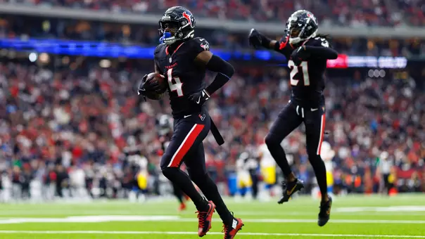HOUSTON, TEXAS - JANUARY 11: Cornerback Kamari Lassiter #4 of the Houston Texans celebrates after securing an interception during the first half of an AFC Wild Card game against the Los Angeles Chargers, at NRG Stadium on January 11, 2025 in Houston, Texas. (Photo by Brooke Sutton/Getty Images)