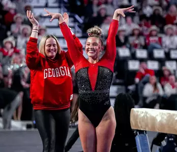Gymnast Brooke Gleichowski completes her beam routine.