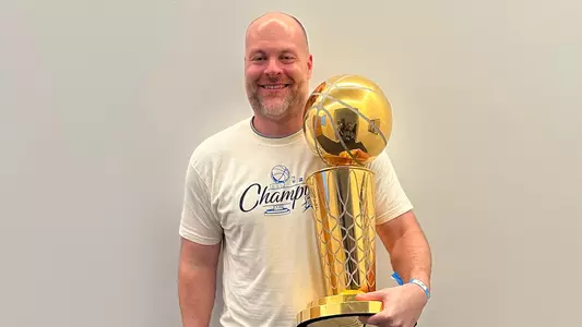 Dave Bliss with the 2025 NBA Championship trophy.