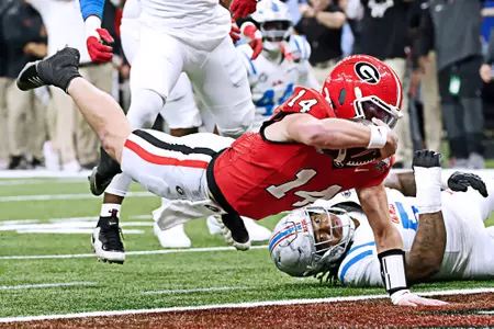 Jan 1, 2026; New Orleans, LA, USA; Georgia Bulldogs quarterback Gunner Stockton (14) scores a touchdown against the Mississippi Rebels in the second quarter during the 2025 Sugar Bowl and quarterfinal game of the College Football Playoff at Caesars Superdome. Mandatory Credit: Amber Searls-Imagn Images