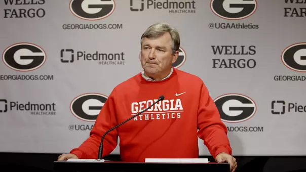Coach Smart at Press Conference standing at podium