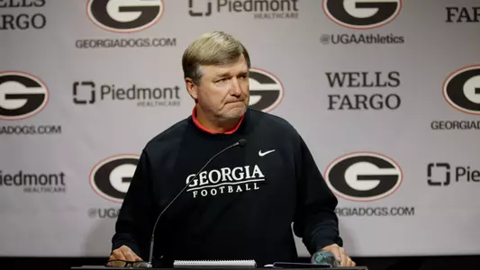Coach Smart standing at Podium during football press conference