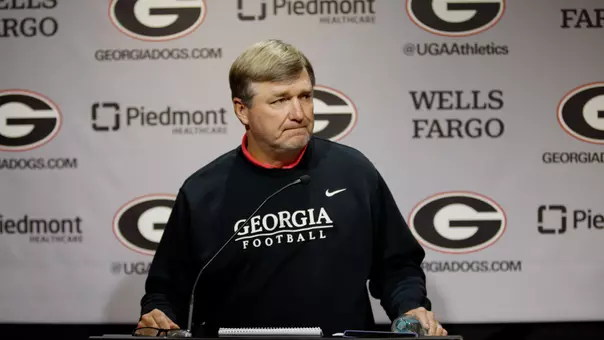 Coach Smart standing at Podium during football press conference