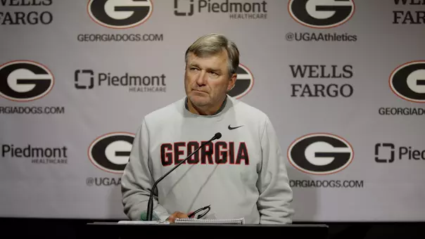 Coach Smart standing at Podium at Press Conference
