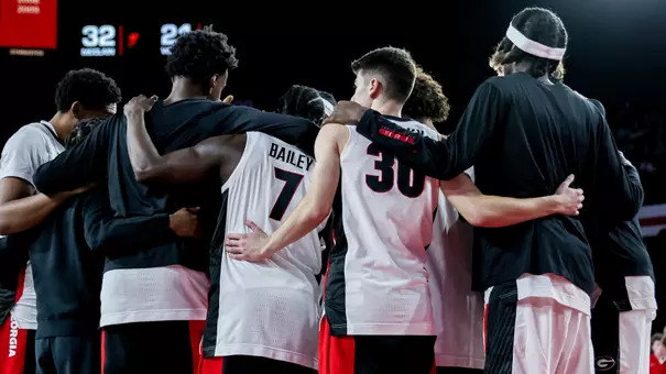 Team huddle before Florida A&M game (photo by Conor Dillon).