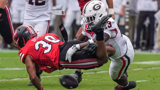 Sep 12, 2026; Athens, Georgia, USA; Western Kentucky Hilltoppers running back Adrion Boyd (29) (wearing 30) fumbles after being hit by Georgia Bulldogs linebacker Anthony Kruah (13) during the first quarter at Sanford Stadium. Mandatory Credit: Dale Zanine-Imagn Images