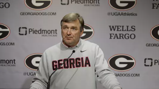 Coach Smart talking at podium in pre-Arkansas press conference