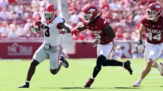 Sep 19, 2026; Fayetteville, Arkansas, USA; Georgia Bulldogs running back Nate Frazier (3) runs with the ball against the Georgia Bulldogs Arkansas Razorbacks defensive back Shelton Lewis (2) during the first half at Donald W. Reynolds Razorback Stadium. Mandatory Credit: Nelson Chenault-Imagn Images