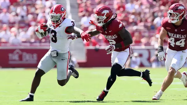 Sep 19, 2026; Fayetteville, Arkansas, USA; Georgia Bulldogs running back Nate Frazier (3) runs with the ball against the Georgia Bulldogs Arkansas Razorbacks defensive back Shelton Lewis (2) during the first half at Donald W. Reynolds Razorback Stadium. Mandatory Credit: Nelson Chenault-Imagn Images