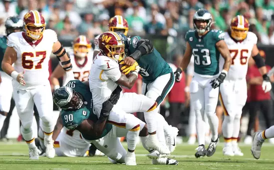 PHILADELPHIA, PENNSYLVANIA - SEPTEMBER 13: Jordan Davis #90 and Nolan Smith Jr. #3 of the Philadelphia Eagles tackle Rachaad White #1 of the Washington Commanders in the first quarter of a game at Lincoln Financial Field on September 13, 2026 in Philadelphia, Pennsylvania. (Photo by Emilee Chinn/Getty Images)