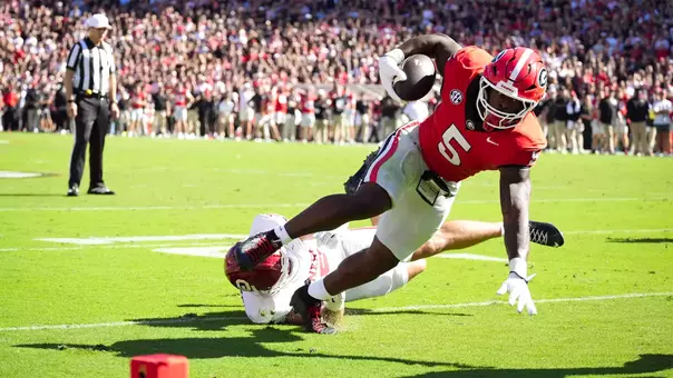 Sep 26, 2026; Athens, Georgia, USA; Georgia Bulldogs running back Chauncey Bowens (5) runs for a two-yard touchdown against Oklahoma Sooners linebacker Owen Heinecke (38) during the first quarter at Sanford Stadium. Mandatory Credit: Dale Zanine-Imagn Images