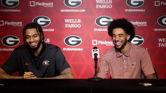 James Scott and Freddie Dilione V smiling at podium