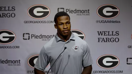 Kyron Jones standing at podium for Football Media Day Press Conference