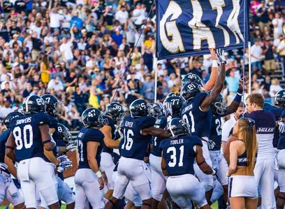 Georgia Southern running in through GATA banner
