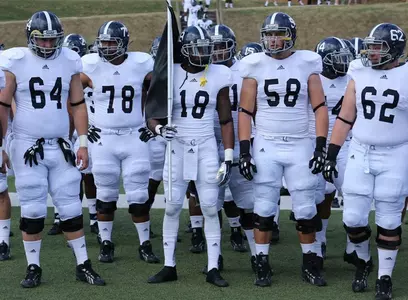 Lavelle Westbrooks carries the black flag onto the field