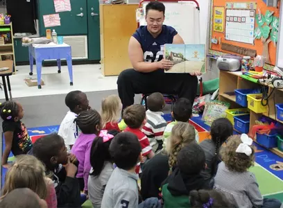 Andy Kwon reads to schoolchildren on Real Men Read Day 2014