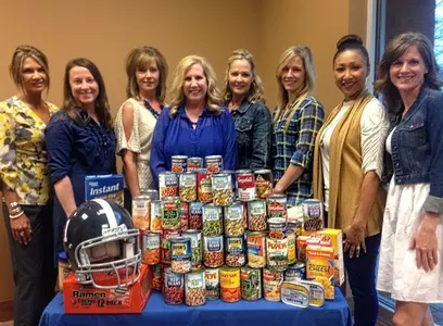 Football Coaches' Wives Donation for Canned Food Drive