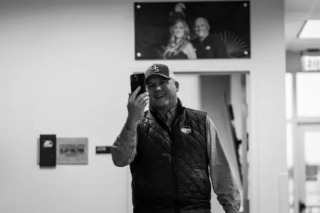 Clay Helton talks to a signee on early National Signing Day 2023