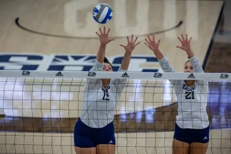 Georgia Southern middle/return specialist Baylor Bumford (13) and Georgia Southern outside hitter Paige Powers (21) during the NCAA womenâ??s volleyball game between Georgia Southern and USC Upstate at Hanner Fieldhouse on August 27, 2022 in Statesboro, Georgia. (Photograph by AJ Henderson / Georgia Southern Athletics)