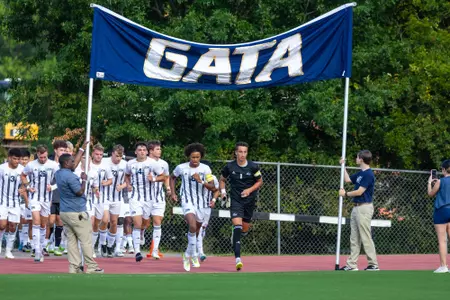 The Georgia Southern men's soccer team takes the field under the team's GATA banner.